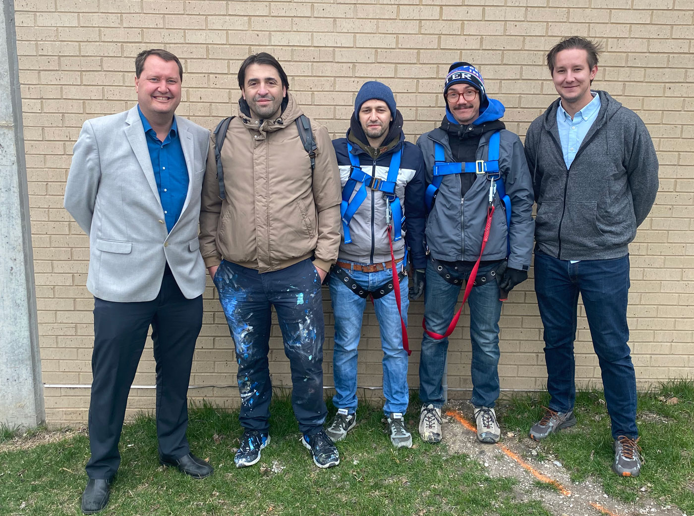 L to R: Jesse Thoeming (executive director, Downtown Cedar Rapids); NEVERCREW Artists Christian Rebechhi, Pablo Togni, and Assistant Alessandro De Bon; and Nick Ludwig (co-chair, Murals & More)