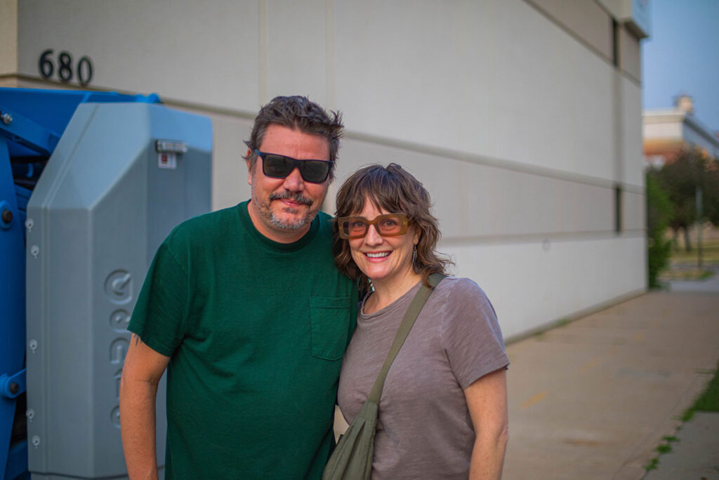 Artist Jennifer Davis (right) and her assistant Brad Senne (left) in front of The Arc where they will paint a large-scale mural in Cedar Rapids, Iowa, Photo by Javier Ducker